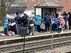 Dozens of migrants, mostly from Venezuela, were dropped off by bus at the Woodstock Metra station Saturday afternoon before continuing on their way to Chicago by train.