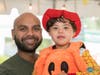 Man holding child in a halloween costume