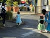 Children in princess costumes crossing the street