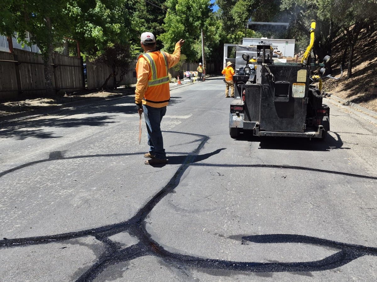 Crew crack sealing a residential street in Lafayette, Ca