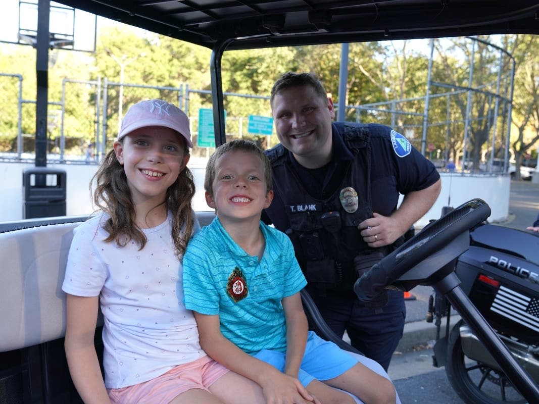 Kids and an officer at National Night Out in Lafayette