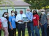 Superintendent Garth Lewis (middle left) and Dr. Roy Wilson, Director, (middle right) surrounded by youth leaders from the Martin Luther King Jr. Freedom Center.