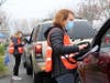 Volunteers assisted with the screening of individuals at a drive-thru clinic in Woodland.