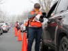 Volunteers assisted with the screening of individuals at a drive-thru clinic in Woodland.