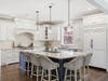 Spacious kitchen featuring high-end appliances, custom cabinetry, large center island, and walk-in pantry.