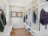 Thoughtfully designed mudroom with five cubbies, storage benches and direct garage access for easy organization.