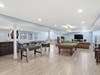 Finished lower level with custom bar, beverage refrigerator, dishwasher, ice maker, and flexible entertaining space.