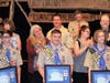 Matthew Lacey, Ben Sanders and Shane Kenyon hold up Eagle certificates with their parents and leaders.