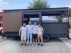 Owners Matthew Modena, Joseph Doheny, Eric Carlson, and Marc Ciarleglio standing outside of their mobile axe throwing trailer during their first event at Bad Sons Beer Co. 