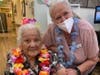 Left: Janet Morikawa and right: Jeannie Combs, life engagement director, enjoy traditional Hawaiian food at the luau themed birthday party.