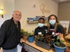 Chelsea Place resident Alan Mitten and students show off their green thumbs.