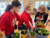 Chelsea Place resident Sandy Savage shares her love of gardening with the students.