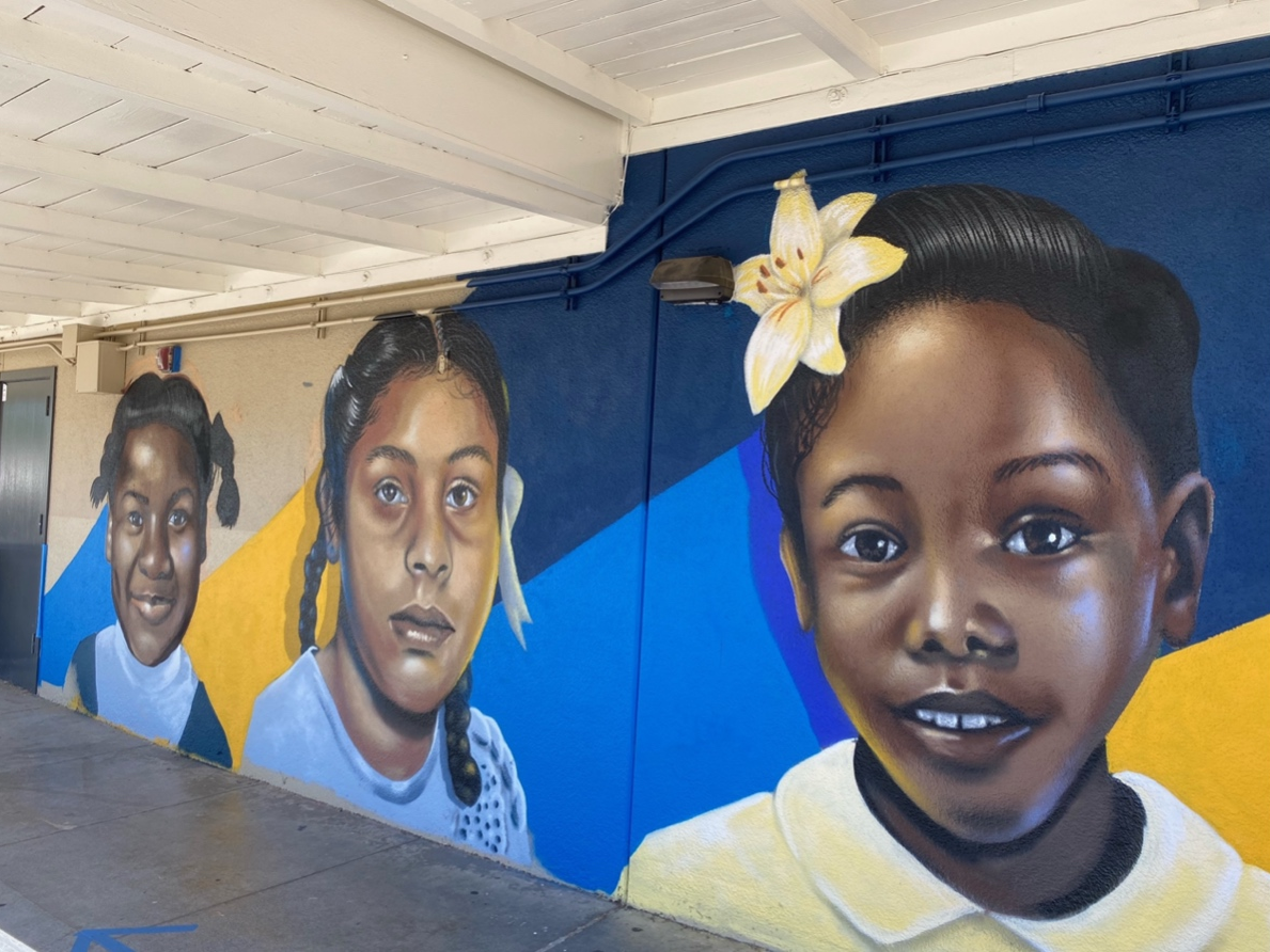 The faces on the wall reflect the students' own diverse backgrounds. Hillcrest, in the Crenshaw area, has a student population made up of Black and Latin American students. 