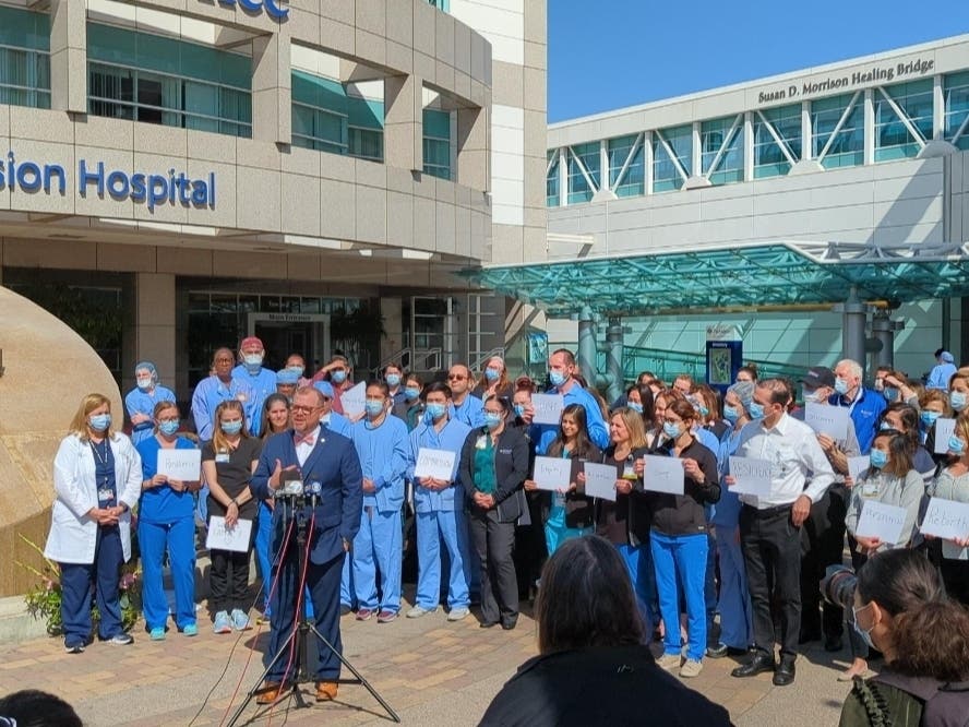 Roughly one hundred healthcare workers, leaders and hospital staff gathered in front of Providence Mission Hospital Wednesday for a moment of reflection and to share hope for a brighter future in light of the COVID-19 pandemic. 