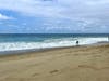 A lone skimboarder catches a wave on Thousand Steps Beach in South Laguna.
