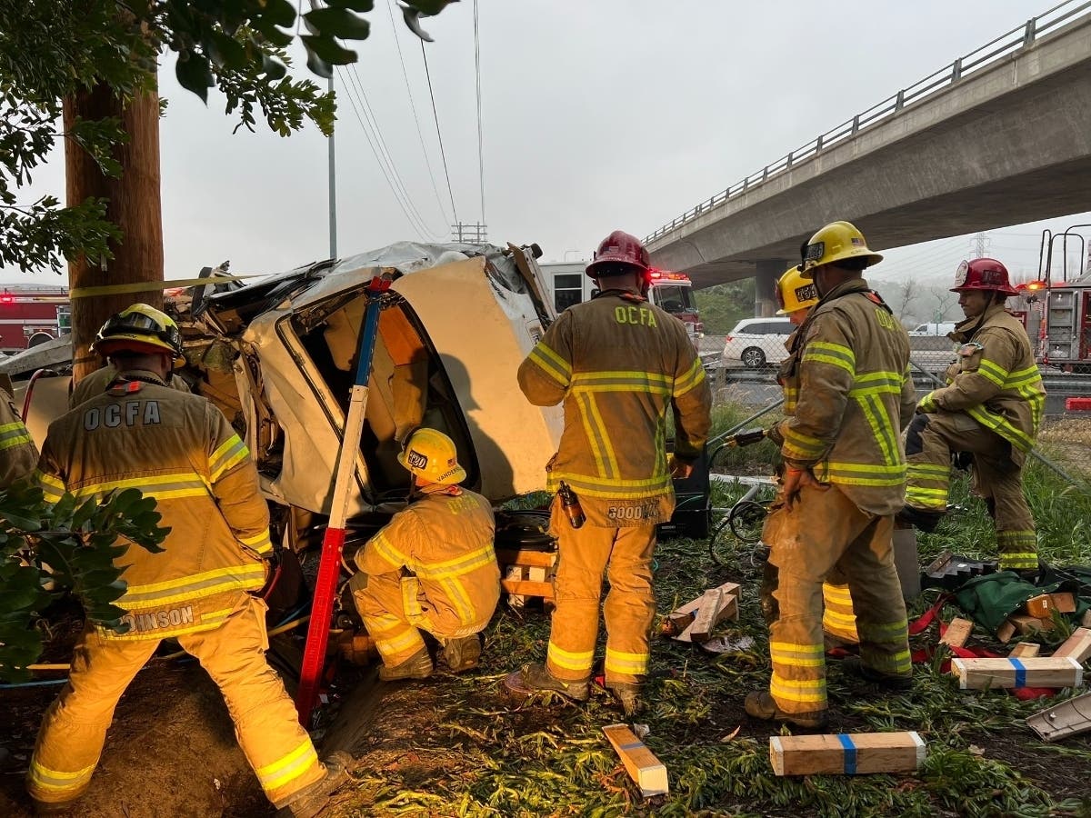 Orange County firefighters pulled off a methodical technical rescue to free a woman who was trapped in her car Monday. 