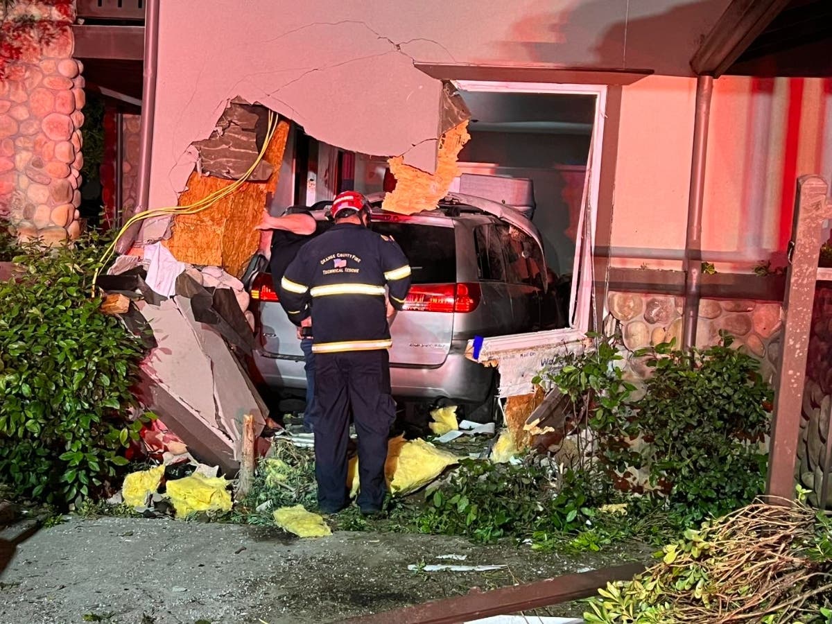 Authorities Tuesday were searching for a man who allegedly crashed a minivan into a Santa Ana apartment complex, leaving after hitting a woman and leaving her in critical condition.