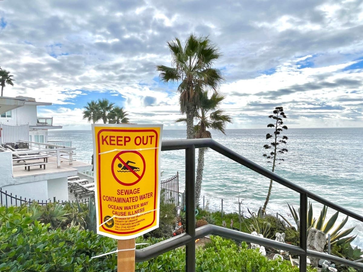 More than two-miles of south Orange County coastline was reopened Sunday, after almost 100,000 gallons of sewage fouled the pristine waters Wednesday.