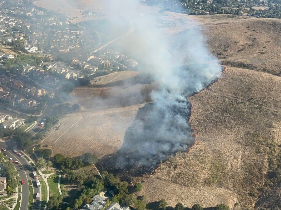 The blaze started about 4:45 p.m. at Narrow Canyon Road and Acaster Way, according to the Orange County Fire Authority.