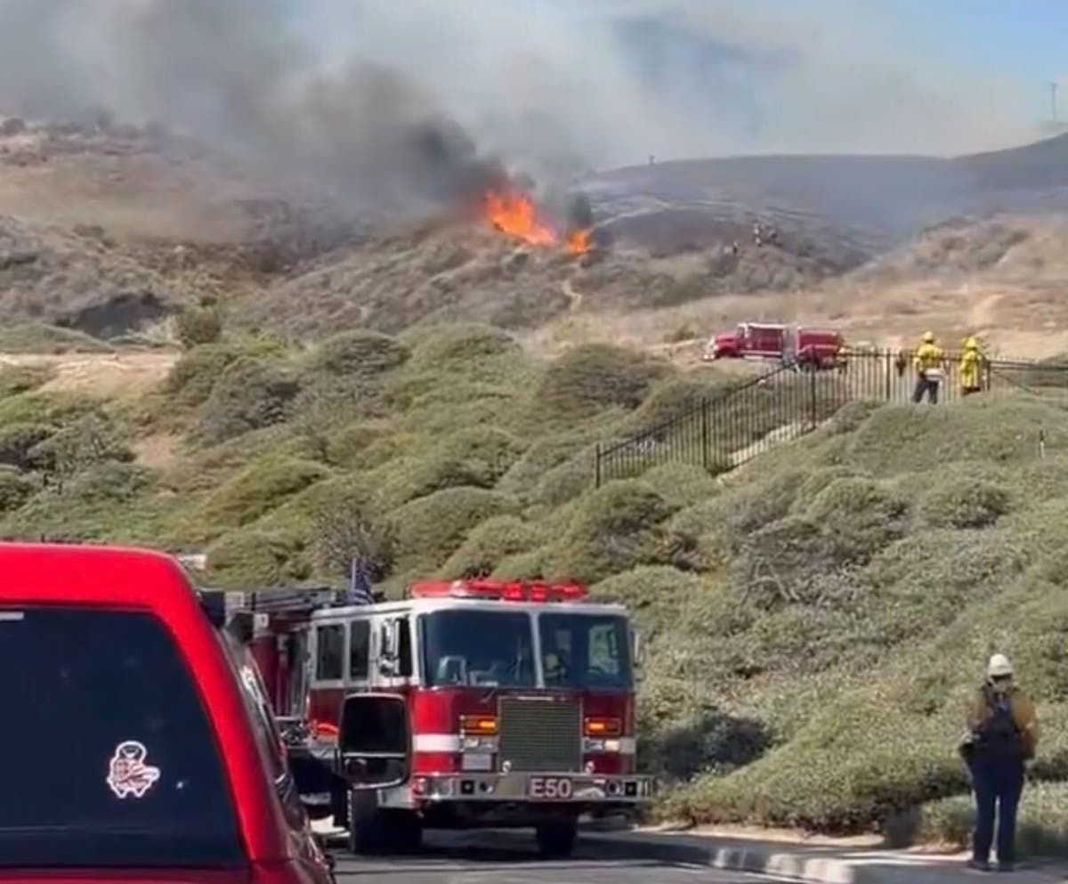 The fire ignited at around 11:30 a.m. Friday in the area of Portico Del Norte and has since been dubbed the Norte Fire, according to the Orange County Fire Authority.