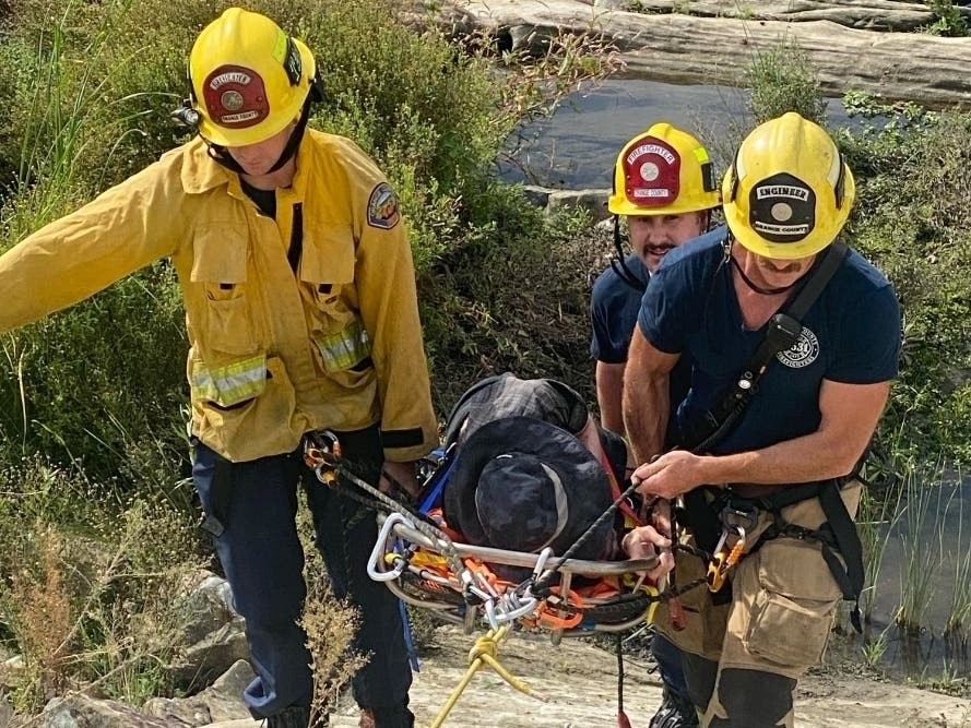 Firefighters received word of the incident at 12:49 p.m. Thursday, when a man feel into a creek embankment along Aliso Creek Trail, according to the Orange County Fire Authority.