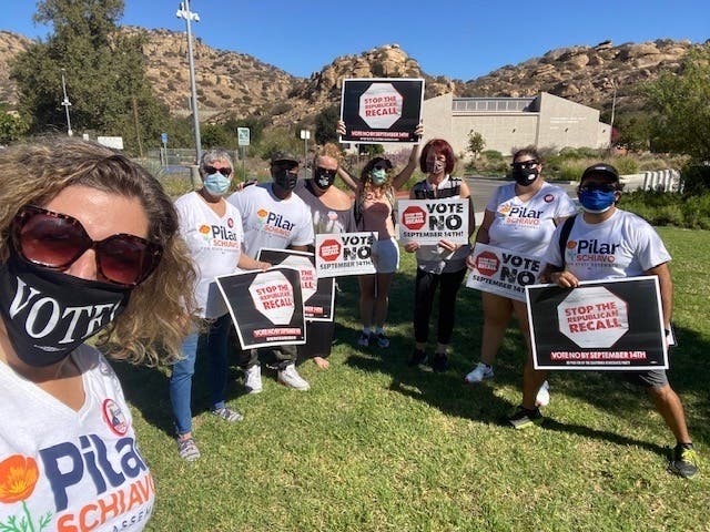Volunteers go door to door in Northridge to help get voters to vote no on Tuesday's gubernatorial recall election. 