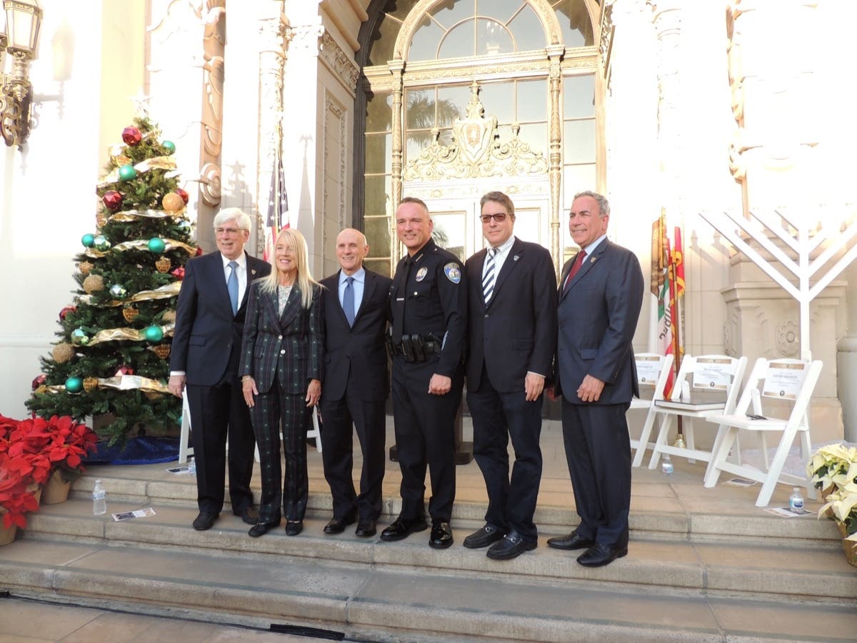 Chief of Police Mark Stainbrook stands outside Beverly Hills City Hall with city council members and Mayor Bob Wunderlich. 