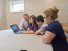 The Kirby family uses resources from jw.org to preview the “Pursue Peace” Convention.