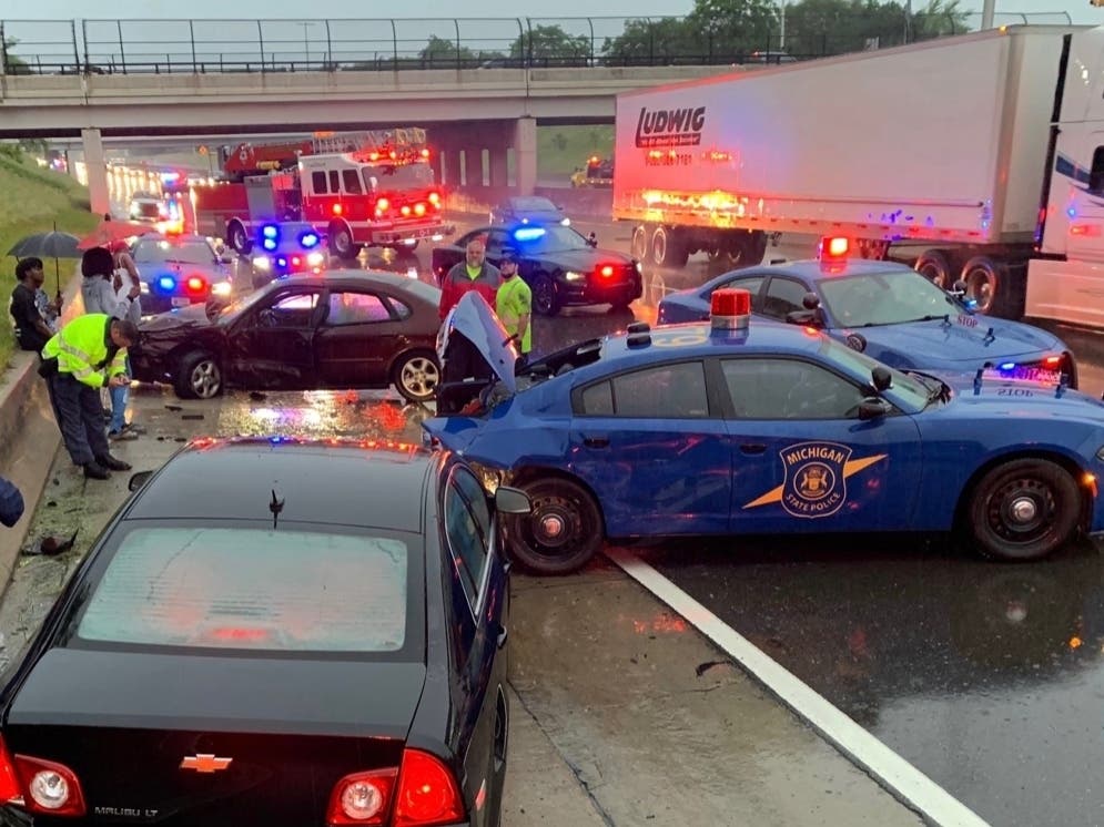 The police cruiser was parked in the right lane on westbound Interstate 94 near 10 Mile Road with its emergency lights on while investigating a separate crash on the freeway, officials said.
