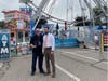 Dearborn Mayor Abdullah H. Hammoud and Councilman Ken Paris pose for a picture in front of the ferris wheel at the Dearborn Homecoming Festival on Friday. 