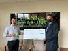 AAEDC Ben Birge presents Goodtimer co-creator Adam Ashley with the first VOLT Growth Fund loan.