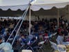 The festival crowd enjoying food and dancing. 