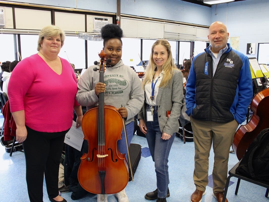 Student cellist Leyla Petit (center left) recently received the scholarship, alongside Director of Music and Arts Dr. Kim Löwenborg-Coyne (left), music teacher Nicole Verderosa (center right) and principal Jonathan Klomp.