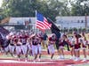 Senior Captain Brendan Staub leads the team onto the field.