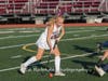 Senior Maeve Carney stick handling down the sideline.