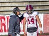 Coach Dave Ettinger gives the play to quarterback Luke Schmitt.