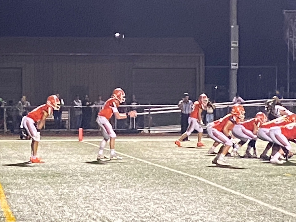 Hersey quarterback Jimmy Makuh (middle) prepares to receive a snap against Glenbrook North on Friday, Sept. 17, in Arlington Heights. 