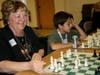 Joan competing in a chess tournament with other players
