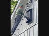 Luca Fariello installs a bat nesting box on the side of a 1700s barn at the Peterson home in Parsippany