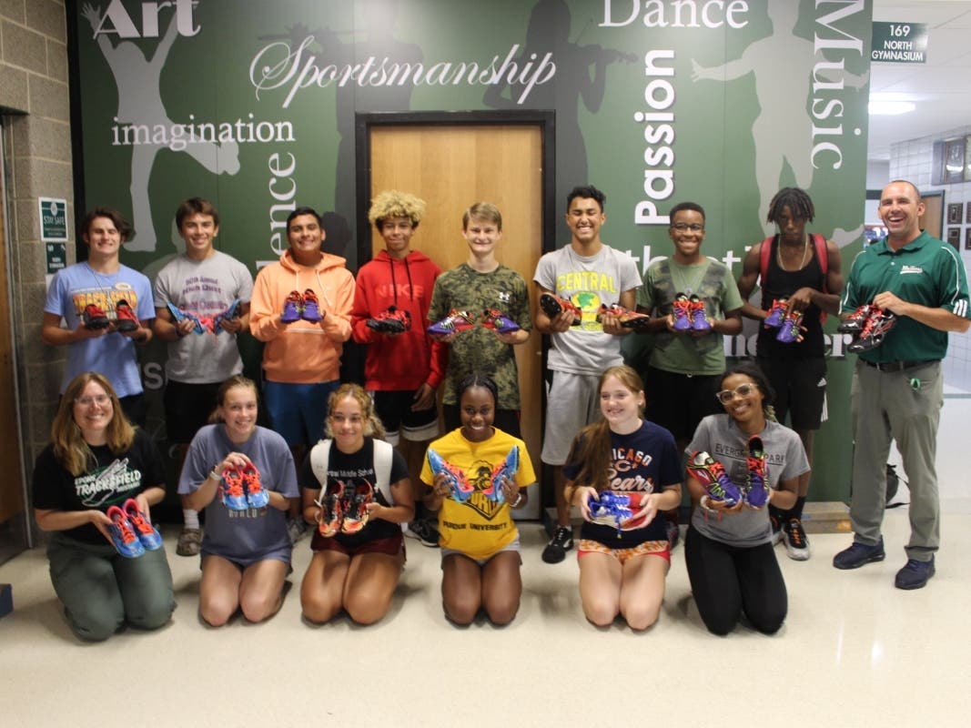 Members of the boys and girls cross country teams at Evergreen Park Community High School show off their new running shoes.