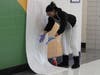 Student Gabby Smith creates blood spatter with red paint during the STEAM collaboration in Forensic Science and Precalculus classes at Evergreen Park Community High School.