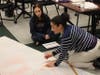 Science teacher Anna Papasideris and student Emma Gabrys discuss the math portion of the project. 