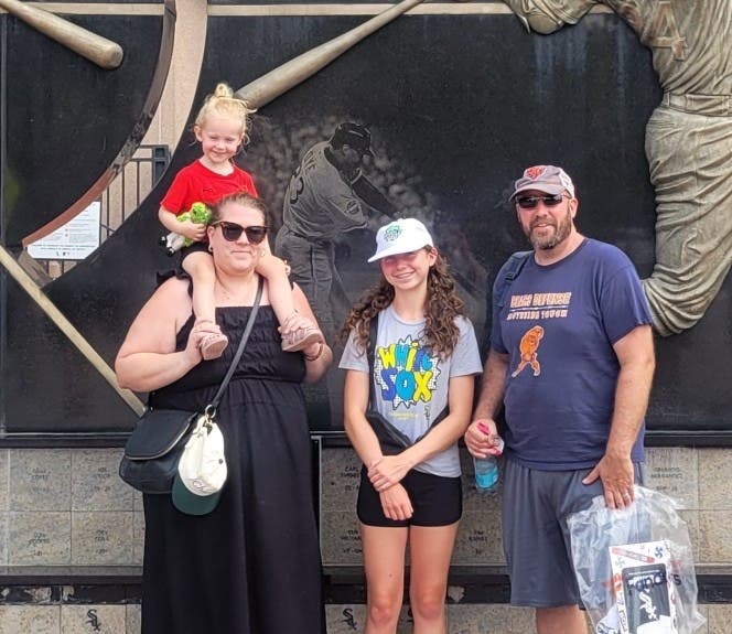 Rhiannon Buehne and her family are shown outside Guaranteed Rate Field, home of the Chicago White Sox, in Chicago. 