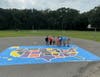 James Gannon from Boy Scout Troop 819 is seen with supporters of his Eagle Scout map project at Prudence Crandall Elementary School. He also painted a second map at Eli Whitney Elementary School in Enfield as part of the project.