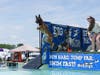 A Chesapeake DockDogs club member with her pup soaring through the air during the Big Air Wave Challenge.