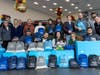 Hawk Subaru Joliet Staff, Subaru Ambassadors, & Subies of the Corn Members with blankets, socks, toiletry kits, & bags to deliver to those experiencing homelessness in the Joliet Area