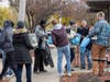 Subaru Ambassadors and Subies of the Corn members distributing the drawstring bags, containing water-resistant blankets, socks, masks, and toiletry kits.