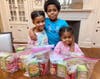 Jack and Jill of Westchester children Logan, Leila, and Norah pose for a quick 
shot while preparing the individual food packages.
