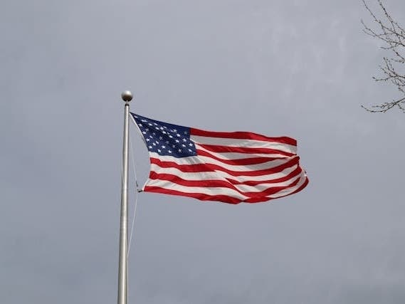 A flag flies against the cloudy skies common in Wisconsin winters