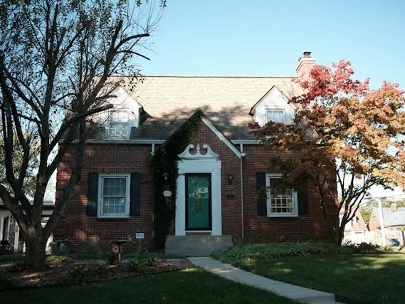 A brick house with a walkway.